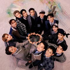 a group of young men standing next to each other in the shape of a heart