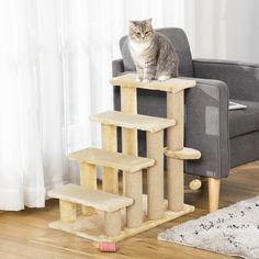 a cat sitting on top of a scratching post in front of a gray chair and white rug