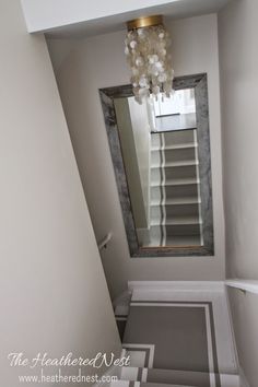 an empty bathroom with a mirror above the toilet