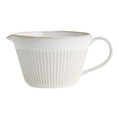 a white coffee cup with pleated design on the rim and bottom, sitting in front of a white background