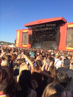 a large group of people standing in front of a stage