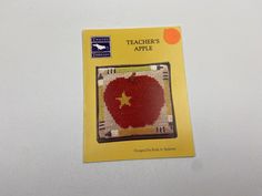 an apple cross - stitch pattern on a card with the words teacher's apple