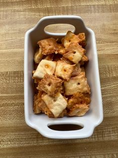 a white container filled with food on top of a wooden table