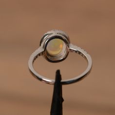 It is a natural opal ring. The main stone is 7mm*9mm oval white opal. The basic metal is sterling silver and plated with rhodium. To change the metal to a solid gold (white/rose) or platinum is also available, please ask for a quotation if you want. You can also go to my shop Home for more elegant rings: https://www.etsy.com/shop/godjewelry?ref=hdr_shop_menu Opal is the birthstone of October, it will be a great gift for your lover! Customization is always welcome and please feel free to contact Elegant Ethiopian Opal Ring With Oval Cabochon, Oval Opal Rings With Polished Finish, Elegant Ethiopian Opal Ring In Oval Cabochon, Elegant Ethiopian Opal Ring Oval Cabochon, Ethiopian Opal Oval Ring For Wedding, Elegant Ethiopian Opal Ring, Oval Cabochon, Elegant Ethiopian Opal Oval Rings, Opal Birthstone Ring Oval Cabochon, Opal Oval Cabochon Ring With Polished Finish