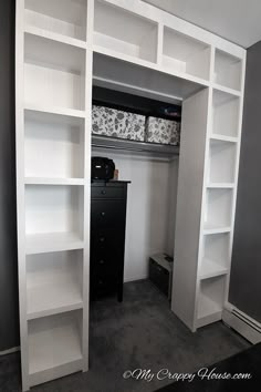 a white bookcase with shelves and drawers in a room that has carpeted flooring