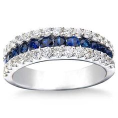 a white gold ring with blue sapphires and diamonds on the sides, set in 18k white gold