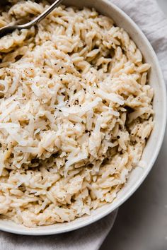 a white bowl filled with rice on top of a table