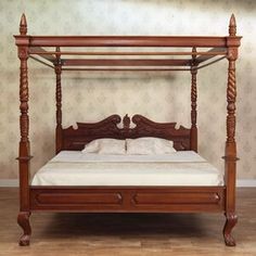 a bed with four posts in a room