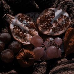 a pomegranate and other fruit on a blanket