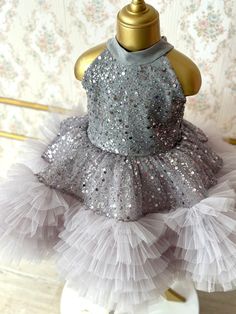 Our enchanting silver sequin tulle dress, is perfectly tailored for your little princess. This hand-crafted dress is made with high quality craftsmanship and perfect for your little one's any special occasion such as birthdays, weddings or for photoshoots. Also an ideal gift option for your family's new little member or for your loved ones' babies! ♥ If you want a custom design (in different color, size, fabric, model etc.), please contact us so we can create your dream piece together! * FABRIC: Silver Sequin and Tulle, for your little princess to shine like a star in her puffy yet light dress. * LINING: 100% Organic Soft Cotton (pre-washed and ironed), ensuring utmost comfort for your little one. * DETAILS: Seams are locked and reversed so that it will not touch your baby's skin and cause Silver Princess Dress For Dress-up, Elegant Silver Dresses For Formal Occasions, Silver Princess Dress For Wedding, Elegant Silver Princess Dress For Wedding, Silver Princess Style Wedding Dress, Silver Princess Wedding Dress, Elegant Sequined Glitter Tulle Pageant Dress, Elegant Pageant Dress With Sequins And Glitter Tulle, Silver Tulle Party Dress