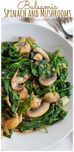 spinach and mushrooms in a white bowl on a plate with silverware next to it