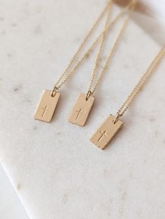 "Dainty cross necklace, 14k Gold Fill, Sterling Silver, Minimalist necklace, Cross gift, Rectangle tag, Religious, Gift for her, Faith necklace, Christian gift, Baptism gift for her, Mothers Day Gift This beautiful cross tag necklace is the perfect piece to wear everyday. PLEASE NOTE: I do not offer back stamping on any item in my shop! D E T A I L S * Gold Filled: Gold Filled Disc, Clasp and Chain. * Sterling: .925 Sterling Silver Disc, Clasp and Chain. P E N D A N T * Size: approx. 5/8\" x 5/1 Dainty Christian Jewelry, Simple Christian Jewelry, Minimalist Crucifix Charm Necklace As Gift, Minimalist Personalized Cross Necklace, Minimalist 14k Gold Cross Necklace As Gift, 14k Gold Filled Cross Pendant Necklace As Gift, 14k Gold Filled Cross Necklace Gift, 14k Gold Filled Cross Charm Necklace For Gift, 14k Gold Filled Cross Charm Necklace As Gift