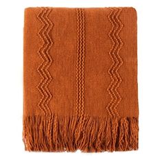 an orange blanket with fringes on it