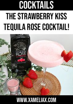 the strawberry kiss tequila cocktail is served in a coupe glass with strawberries on top