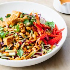 a white bowl filled with salad and tofu