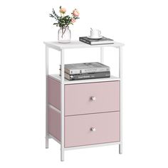 a white and pink nightstand with flowers on top, bookshelf next to it