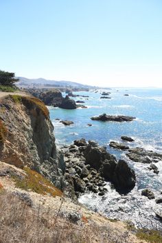 an ocean view from the top of a hill