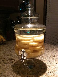 a glass jar filled with food sitting on top of a counter next to a banana peel dispenser