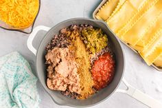 a pan filled with different types of food next to other dishes and utensils