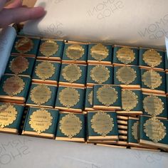 a box filled with lots of blue and gold books