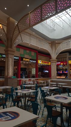 the inside of a restaurant with tables and chairs