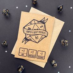 happy birthday greeting card with dices and paper on black surface surrounded by small stars