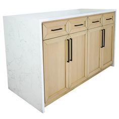 a white counter top with two black handles and some wood doors on it's sides