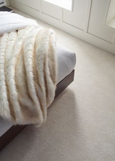 a bed that has some blankets on top of it