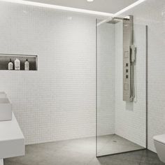 a bathroom with a toilet, sink and shower stall in the middle of the room