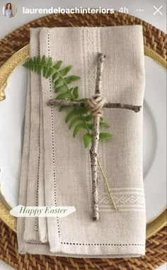 a place setting with napkins and greenery