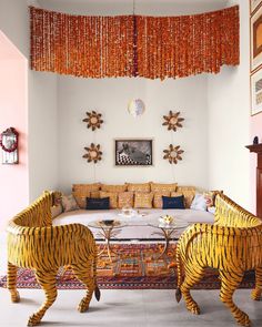 a living room filled with lots of furniture covered in wickers and tiger decorations