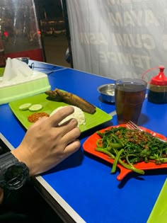 a person sitting at a table with food on it