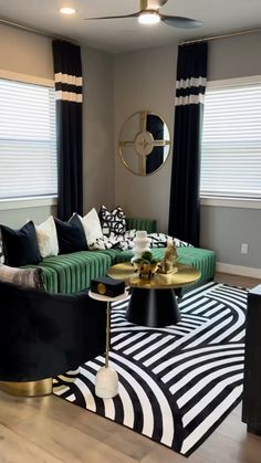 the living room is decorated in black, white and green with pops of gold on the coffee table