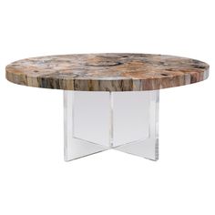 a round marble table with clear acrylic legs and a wooden top on an acrylic base