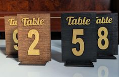 three wooden signs with numbers on them sitting next to a piano