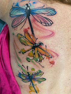 a woman's chest with dragonflies painted on it