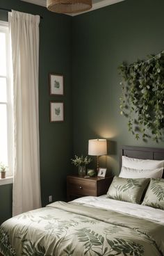 a bedroom with green walls and white drapes on the window sill, along with a bed