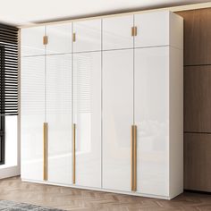 a large white cabinet with gold handles in a room next to a window and rug