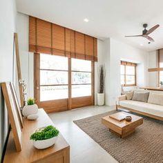 a living room with white walls and wooden furniture