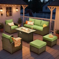 an outdoor patio with green furniture and lights