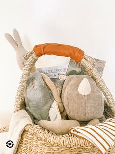 a basket filled with stuffed animals sitting on top of a table