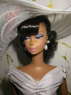 a doll wearing a white hat and dress