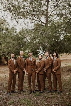 a group of men in brown suits standing next to each other