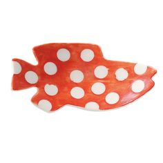 a red and white fish shaped dish with polka dots on it's body, sitting in front of a white background