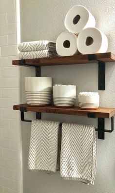 bathroom shelves with towels and toilet paper on them