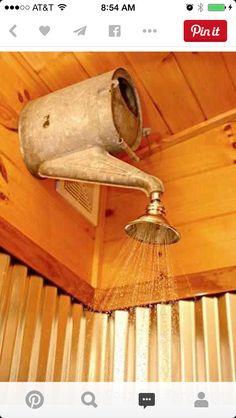 an old fashioned shower head is sprinkled with water