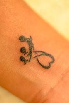 a small tattoo on the wrist of a person