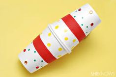 a roll of toilet paper wrapped in red and white polka dots on a yellow background