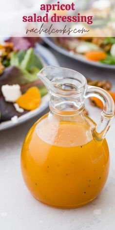 a glass jug filled with salad dressing on top of a table next to other plates