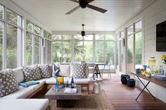 a living room filled with furniture and lots of windows